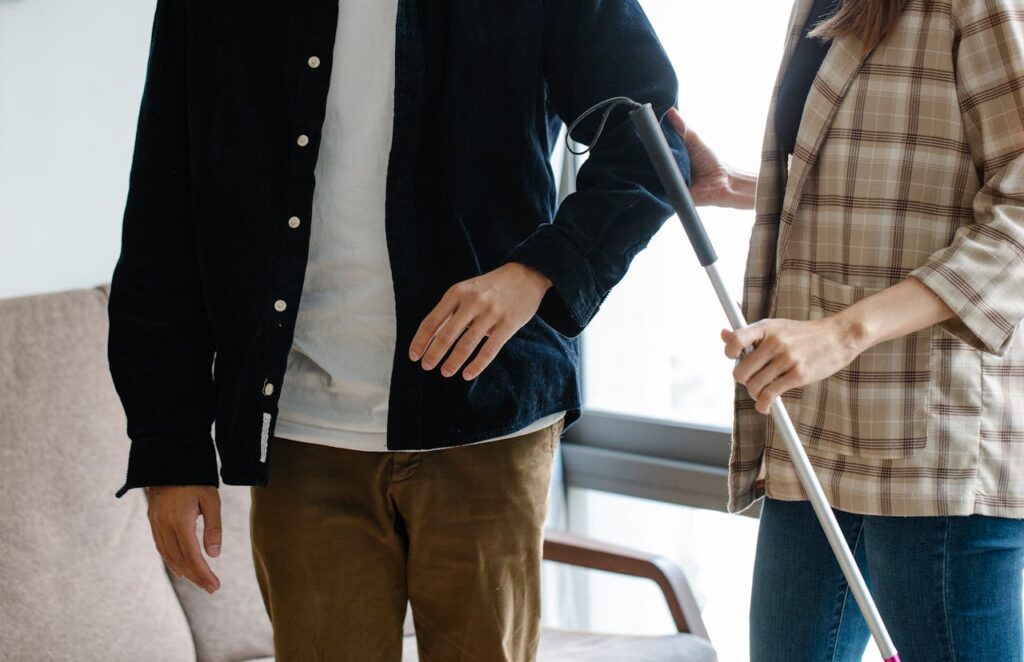 Photo of Person Holding Walking Stick 